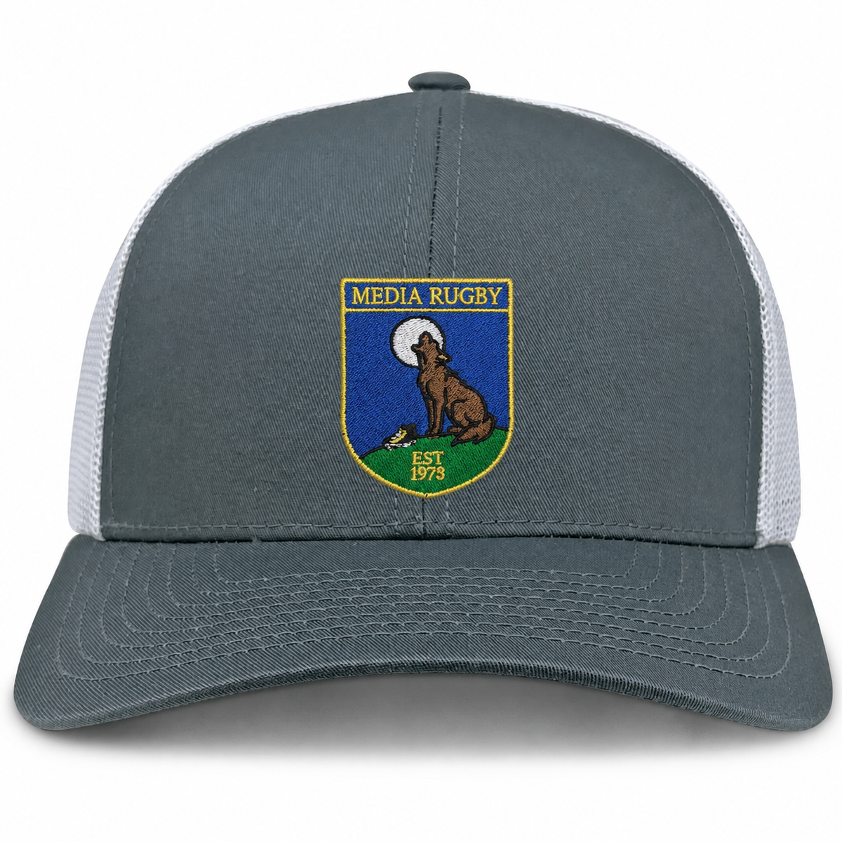 The Media Rugby Retro Trucker Cap by EMB S&S Activewear features a gray and white design with a front patch depicting a howling wolf, a full moon, and the words “MEDIA RUGBY EST 1973.” It is finished with a classic snapback closure for an adjustable fit.