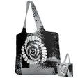 The Missoula All-Maggots Denver Packable Zip Tote by Teamatical features a black and white abstract spiral design and comes with a small matching pouch.