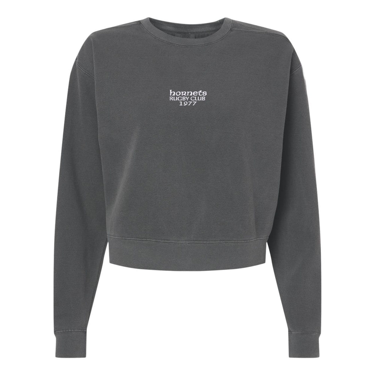The EMB S&S Activewear Hornets Rugby Club 1977 Women’s Garment-Dyed Mid-Length Crewneck Sweatshirt features a dark gray color, small “hornets RUGBY CLUB 1977” print in white on the front center, and is crafted from heavyweight fleece for lasting comfort and warmth.