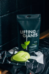 A bag of Lineout Lifting Supports by Lifting Giants sitting on a black table, showcasing their natural hand positions and lineout lifting supports.