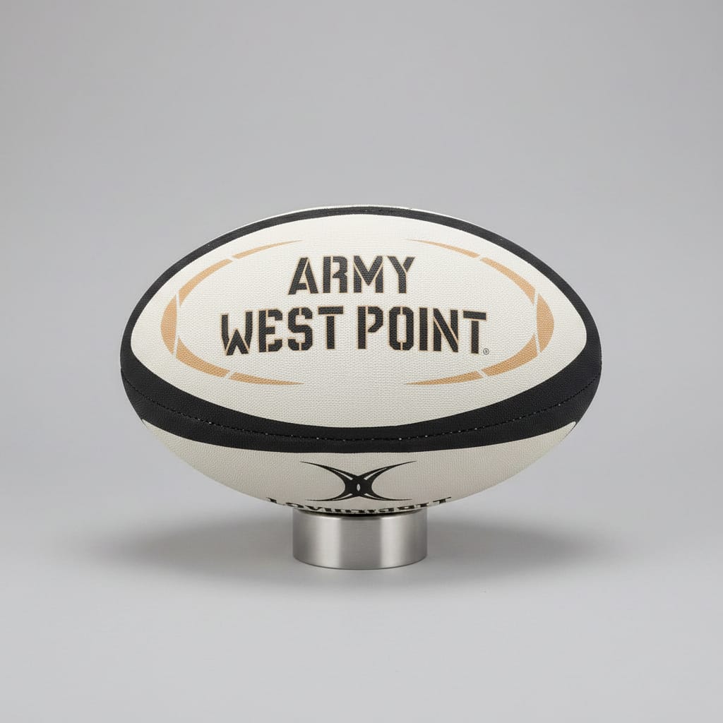 The Army West Point Gilbert Omega Match Ball by Gilbert is displayed on a stand against a dark background.