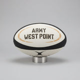 The Army West Point Gilbert Omega Match Ball by Gilbert is displayed on a stand against a dark background.