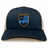 Introducing the New York Police Dept. Rugby Retro Trucker Cap by EMB S&S Activewear—a navy blue and white snapback featuring an embroidered NYPD shield with a city skyline, scales of justice, and crossed batons. Designed for an adjustable fit with its classic snapback closure, this cap blends timeless style and iconic details, perfect for true fans.