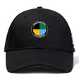 The SOCAL SANZAS RFC Flexfit Drill Cap by EMB Canterbury is a black cap with a circular embroidered logo in black, yellow, green, and blue labeled "Savages International SoCal Rugby Club.