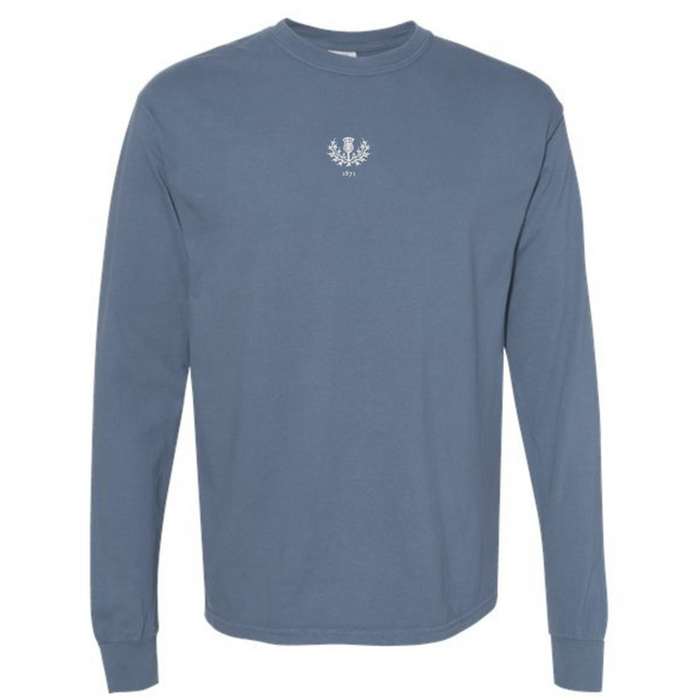 The EMB S&S Activewear Scotland Vintage Long Sleeve Comfort Tee features a blue crewneck design with a small white laurel wreath and "1977" on the upper chest, inspired by classic Scottish style.