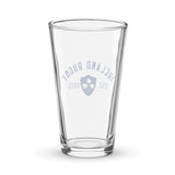 A clear navy shaker pint glass by PF LIC, featuring a design that reads "Ireland Rugby Est. 1875" along with a shamrock emblem, this handmade piece of glassware celebrates the rich heritage of Ireland rugby.