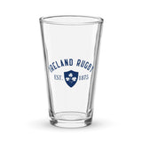 The PF LIC Ireland Est 1875 Navy Shaker Pint Glass is a handmade piece featuring the text "Ireland Rugby Est. 1875" along with a blue emblem adorned with shamrocks.