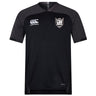 The Troy University Rugby Vapodri Evader Jersey by Canterbury, in black and dark gray with a collar, features a white logo on the left chest and an EMB Canterbury logo on the right. This jersey is enhanced with moisture-wicking technology to ensure optimal comfort during intense activities.