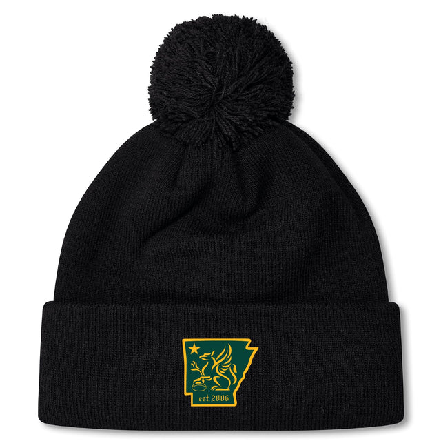 The Arkansas Gryphons Pom Pom Beanie by EMB Canterbury features black fleece lining, a pom-pom, and a yellow-green embroidered Arkansas patch with lion and "est 2006"—a custom rugby hat for fans.
