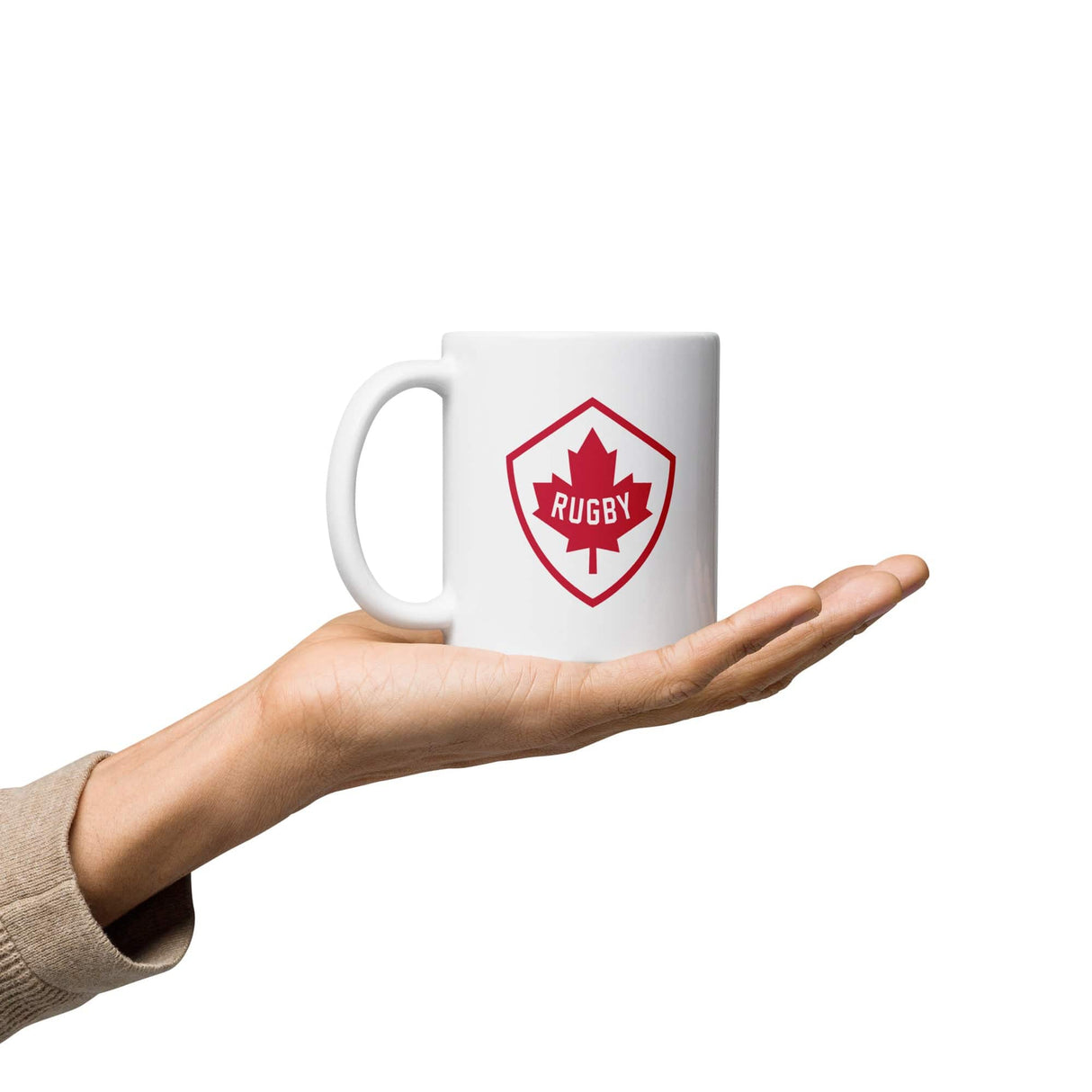 A Canadian rugby fan proudly holding a PF LIC Rugby Canada White Glossy Mug adorned with the flag of Canada.
