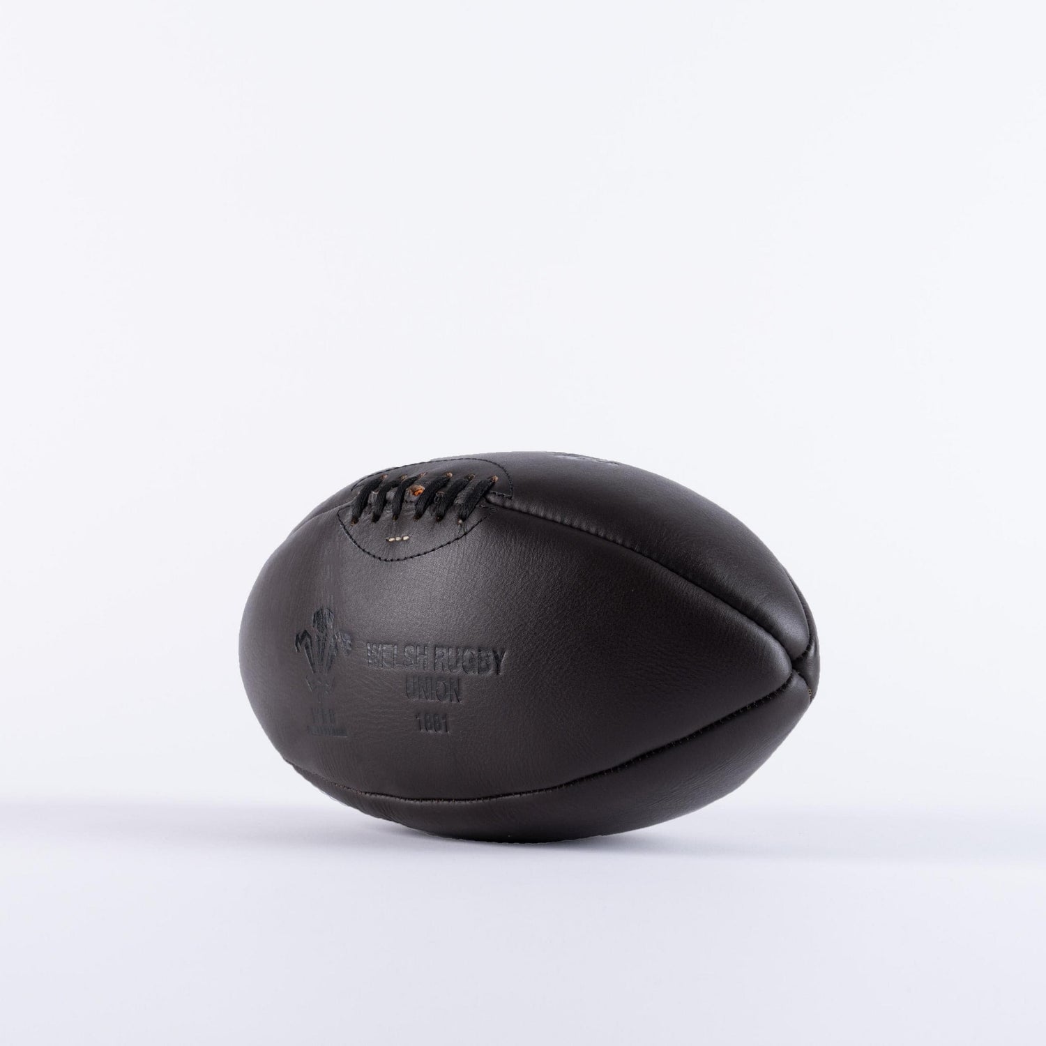 A black leather Wales Rugby Vintage Leather Ball by Gilbert on a white background.