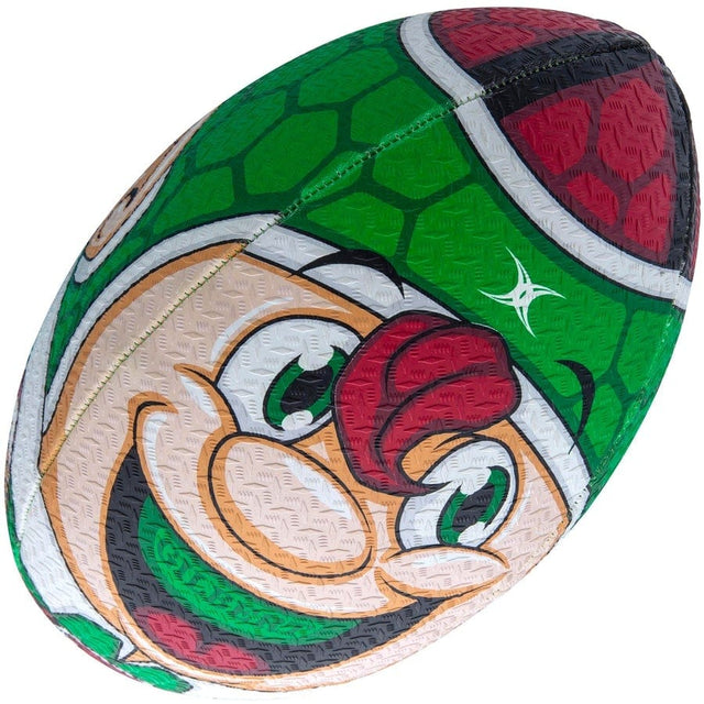 A close up of a green and red Gilbert BALL RANDOMS XMAS ELF SZ 5 football.
