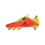 A adidas Kakari Z.0 SG - Solar Red soccer shoe on a green background.