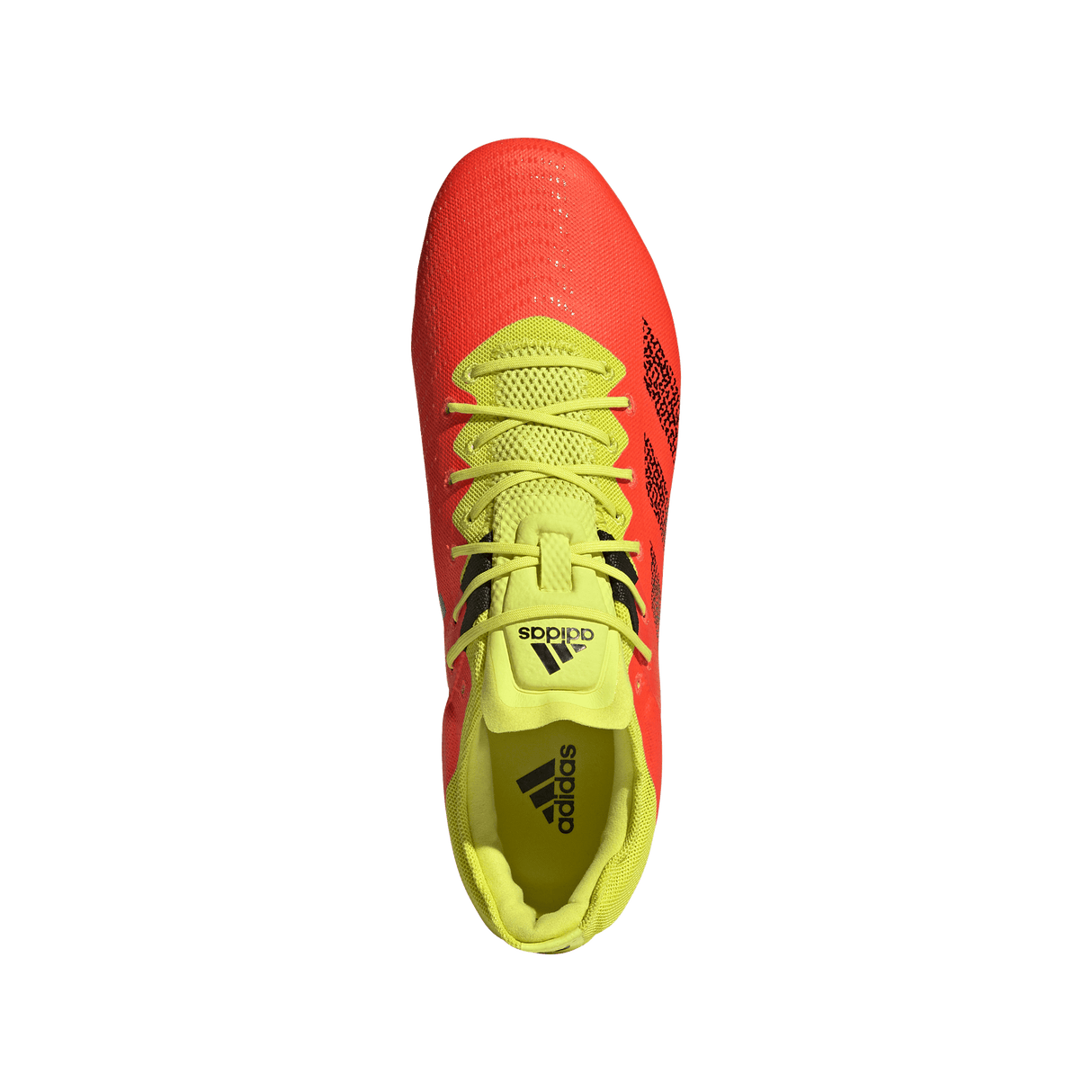 A pair of adidas Kakari Z.0 SG - Solar Red shoes on a green background.