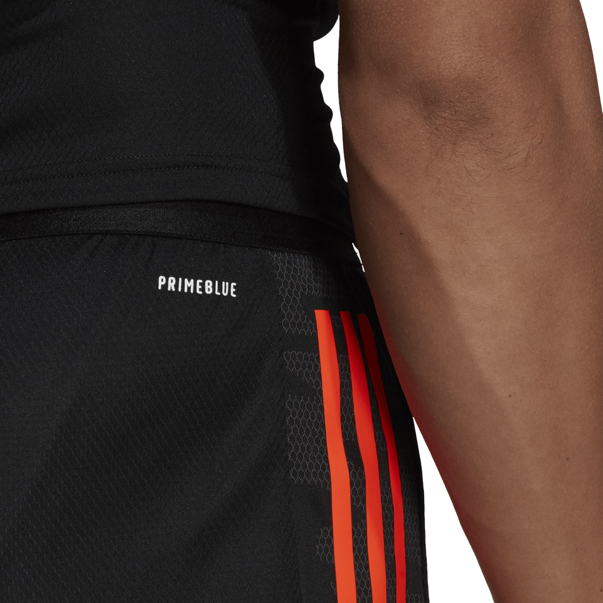 A man's All Blacks Gym Shorts by adidas with orange stripes.