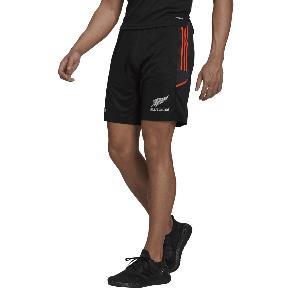 A New Zealand rugby player in All Blacks Gym Shorts by adidas in black and orange.