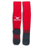Long red rugby socks with Gilbert logo mid calf, gray foot with red stripes on ankle and across the center of the sole.