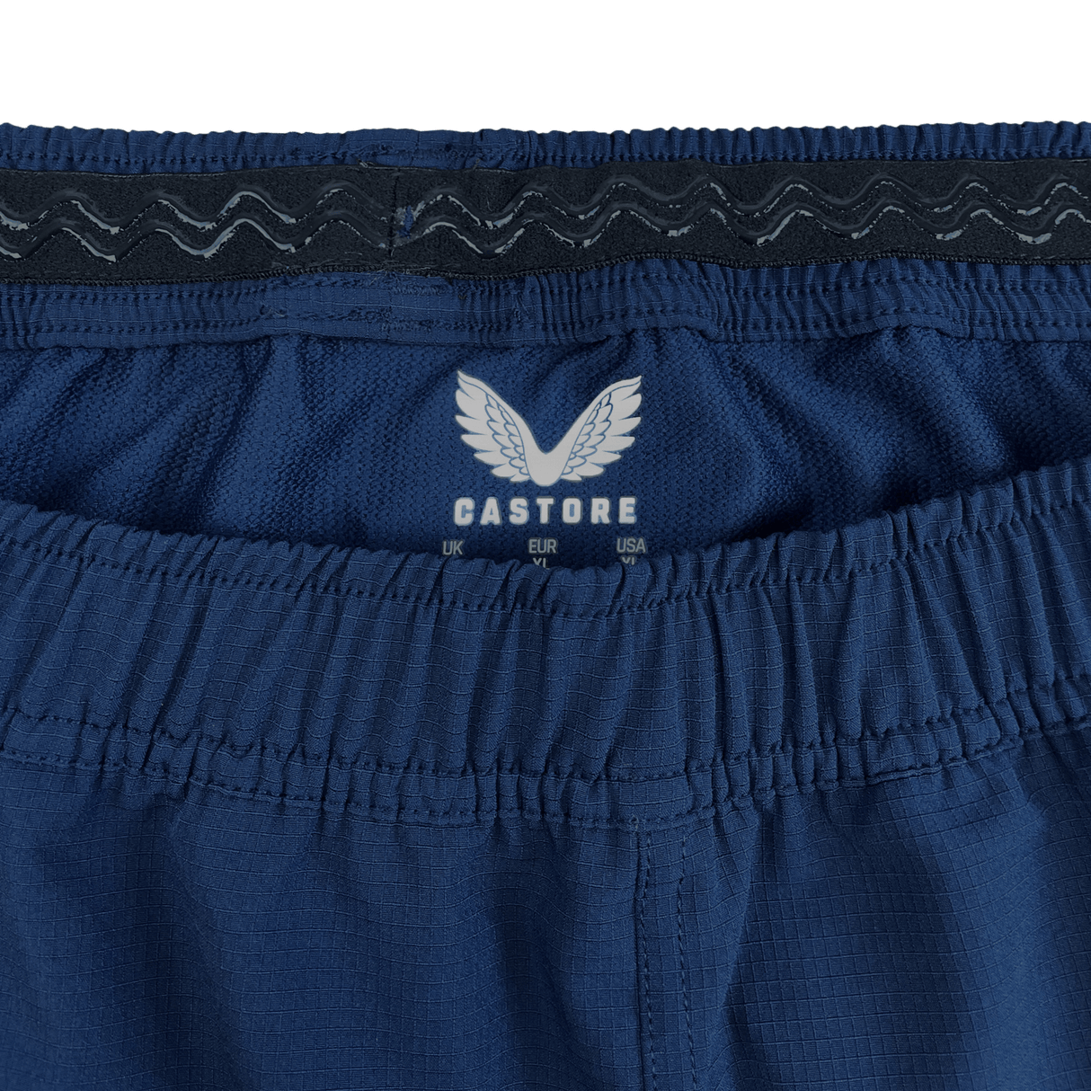 Detail of elastic waist and inside rubberized wave lines to hold the short in place. A white Castore logo printed in the back of the short under the waist band. 