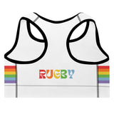 Back of white sports bra with black piping, rainbow stripes on each side and a multi-colored 'RUGBY' inscription across the center. 