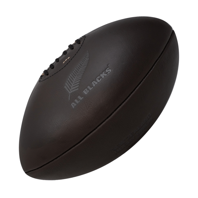 A Gilbert All Blacks Vintage Leather Ball on a black background.