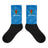 Crew socks with black feet and a blue on blue geometric design up the leg with a Manu Samoa logo.
