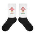 A pair of Wales Rugby Union Sublimated Crew Socks with black feet, white leg andthe WRU logo on it.