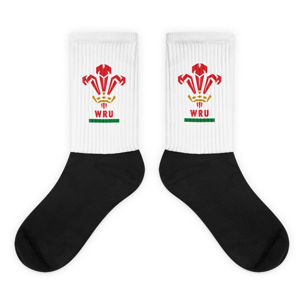 A pair of Wales Rugby Union Sublimated Crew Socks with black feet, white leg andthe WRU logo on it.