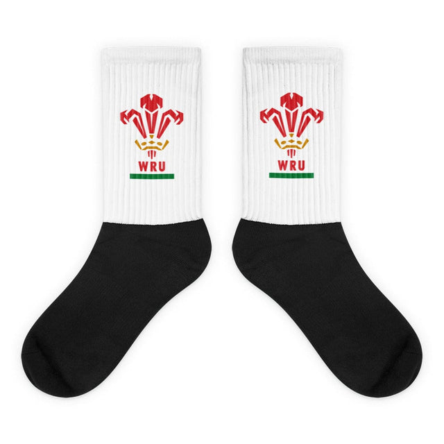 A pair of Wales Rugby Union Sublimated Crew Socks with black feet, white leg andthe WRU logo on it.