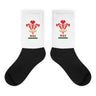 A pair of Wales Rugby Union Sublimated Crew Socks with black feet, white leg andthe WRU logo on it.