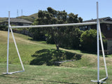 A Packaworld Packapost Full Sized Portable Rugby Post in the middle of a yard.