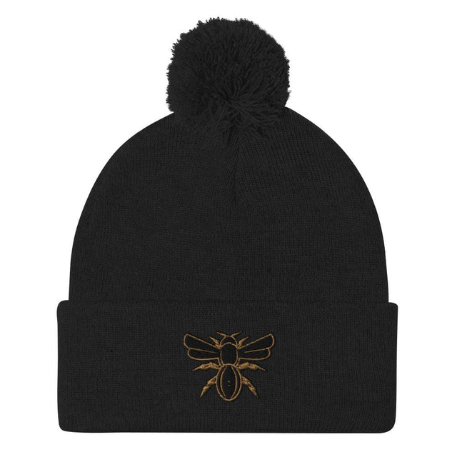 A Rugby Hive Pom-Pom Beanie with a gold bee on it.