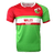 Wales rugby round neck short sleeve jersey. Upper red back, right shoulder and sleeve, white round collar, and green left shoulder and sleeve trimmed in red. Green horizontal stripe across the upper chest with white stripe below and red stripe below the white. Green lower torso.  