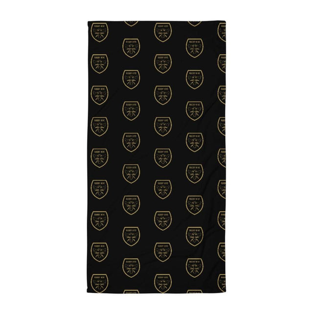 A Rugby Hive Towel with a pattern of shields in black and gold.