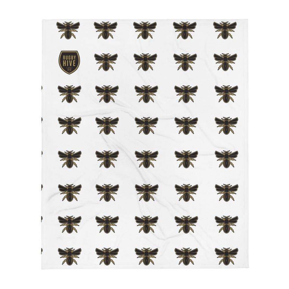 A white Rugby Hive Blanket with black bees on it.