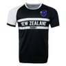 Round neck short sleeve jersey. White right shoulder trimmed in black. Chest and right shoulder in black. Two white center stripes with New Zealand in the center and Rugby below. The New Zealand flag sits on the upper left chest.