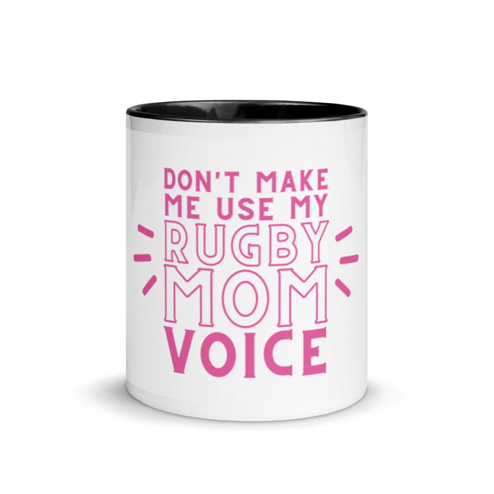White ceramic mug with black interior and a pink 'don't make me use my rugby mom voice' inscription.