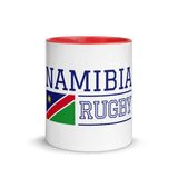 White ceramic mug with red interior and handle and a Namibia Rugby blue inscription aside a Namibia flag.