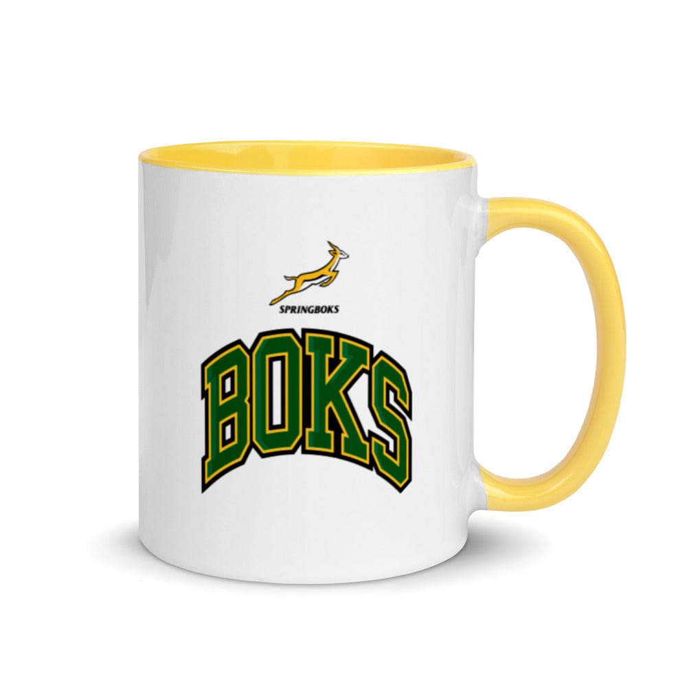 A white and yellow South Africa Springboks Rugby mug with the words books on it.