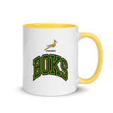 A white and yellow South Africa Springboks Rugby mug with the words books on it.